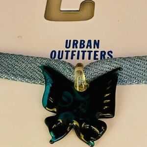 Urban Outfitters turquoise glass butterfly pendant on a blue fabric band choker